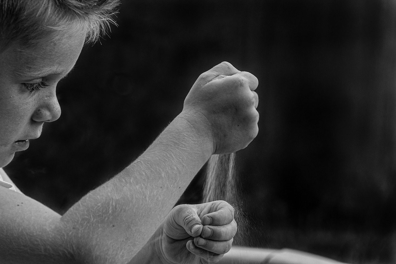 Child playing with sand - black and white photo