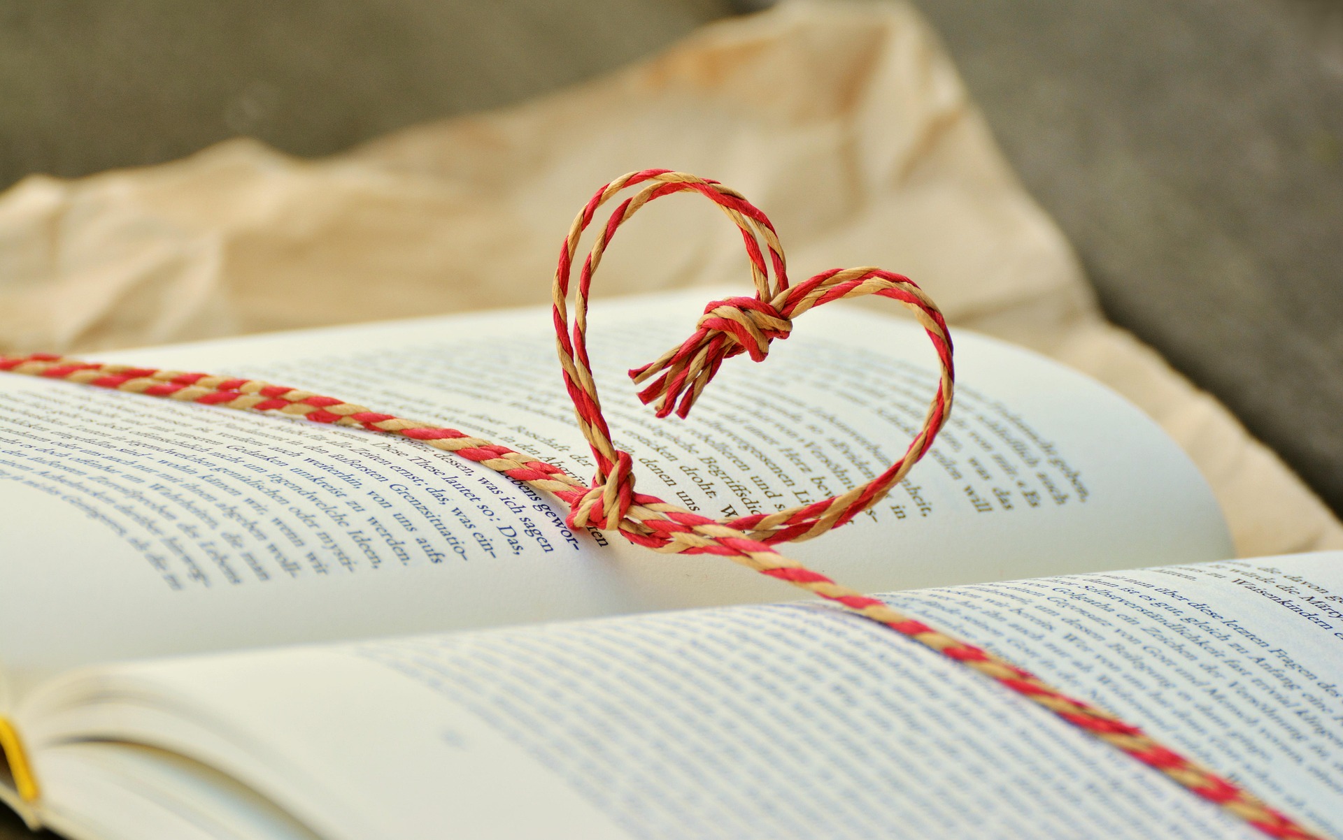 open book with heart string wrapping