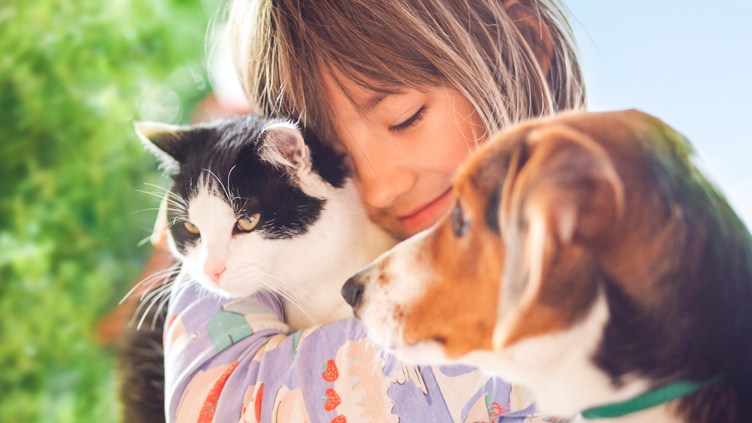 young girl with a cat and dog