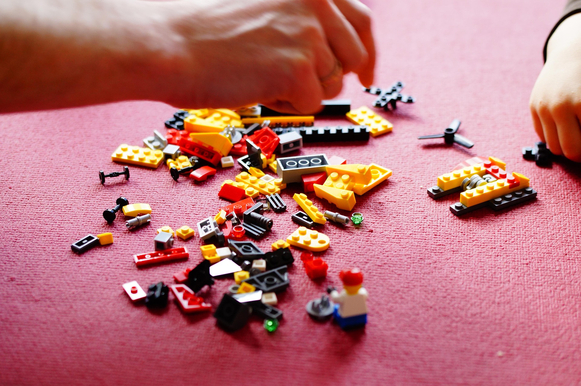 Pile of Legos with two people building