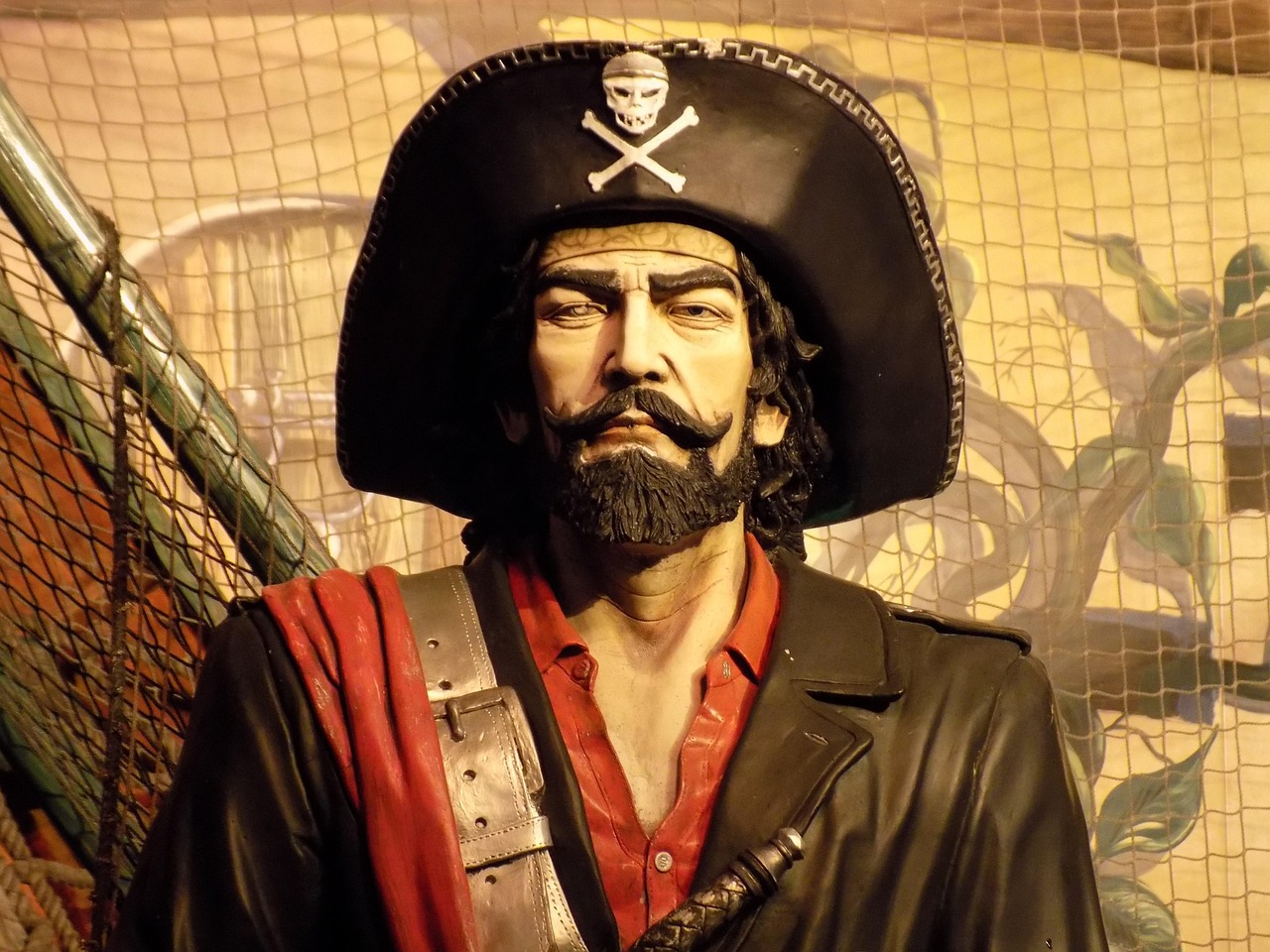 Pirate image standing in front of yellowed map