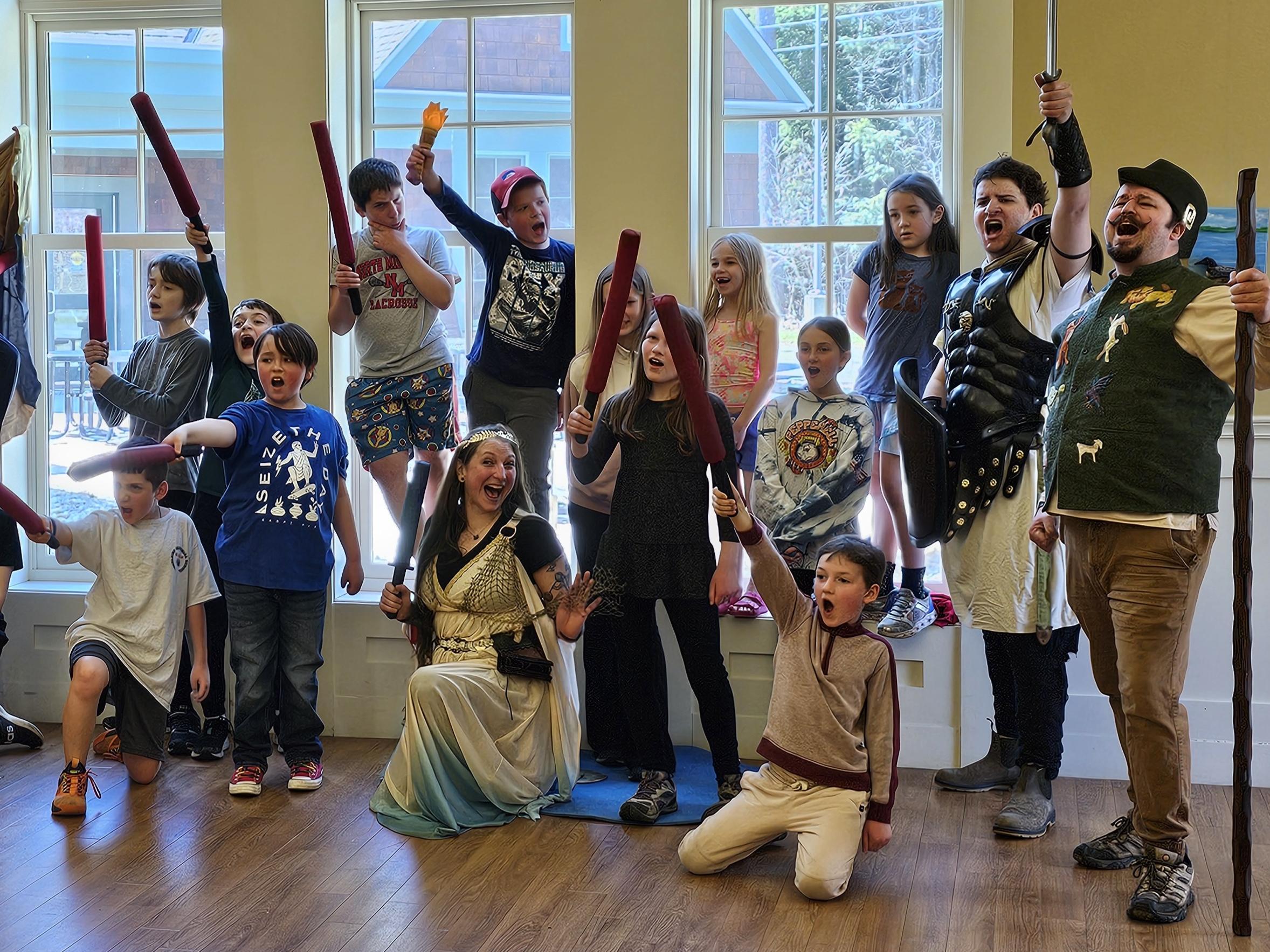 Students posing with play swords at the library