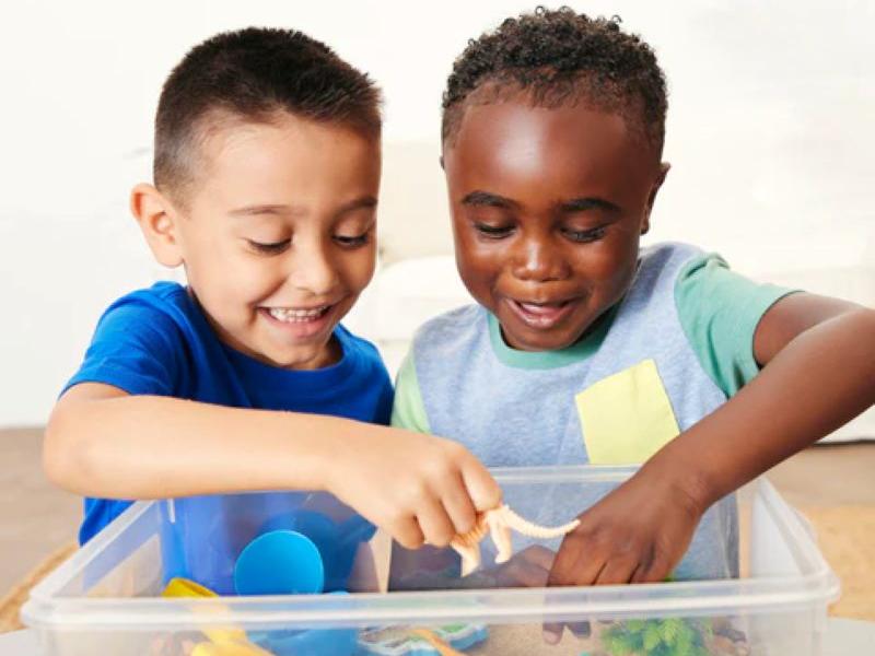 2 boys playing with sensory bins