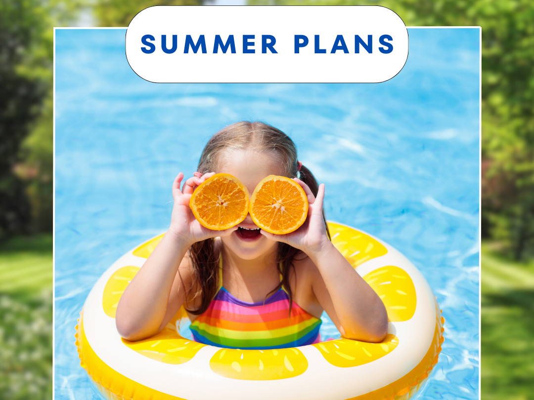 Girl in floaty in a pool with oranges over her eyes.