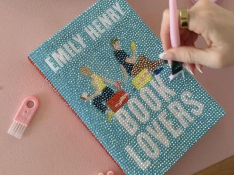 The title Book Lovers by Emily Henry being bedazzled with gems