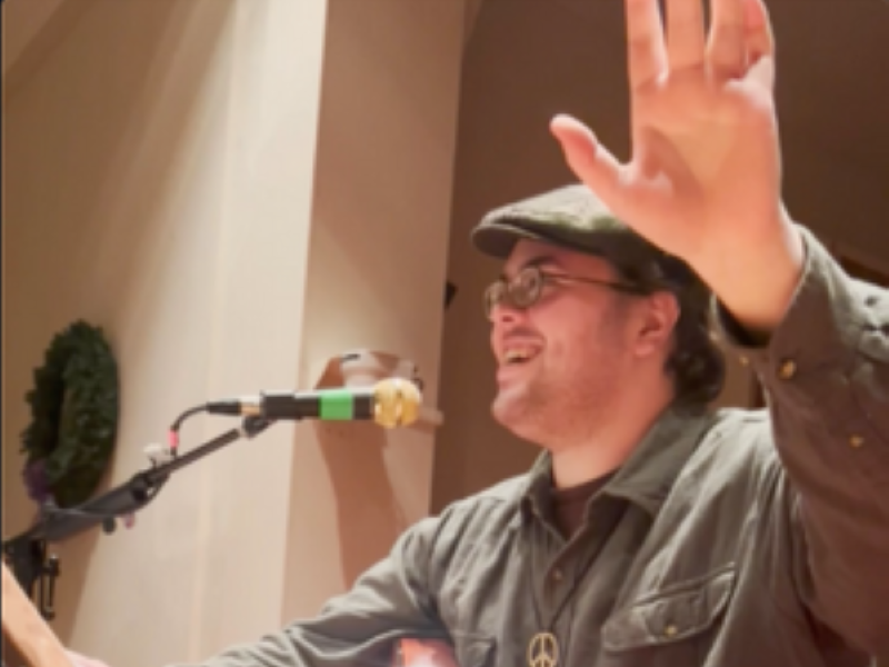 picture of Thomas Kelley in front of microphone