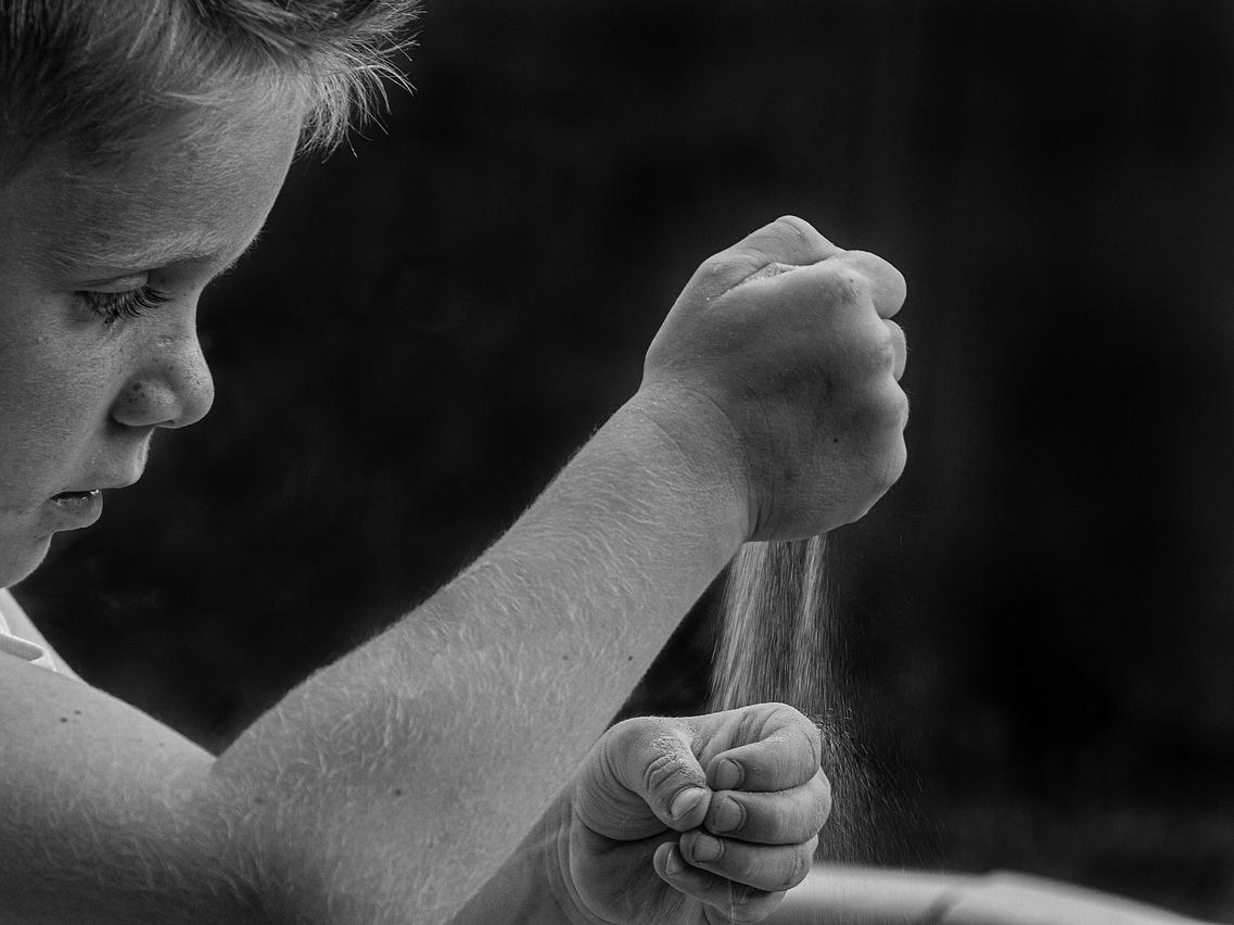 Child playing with sand - black and white photo